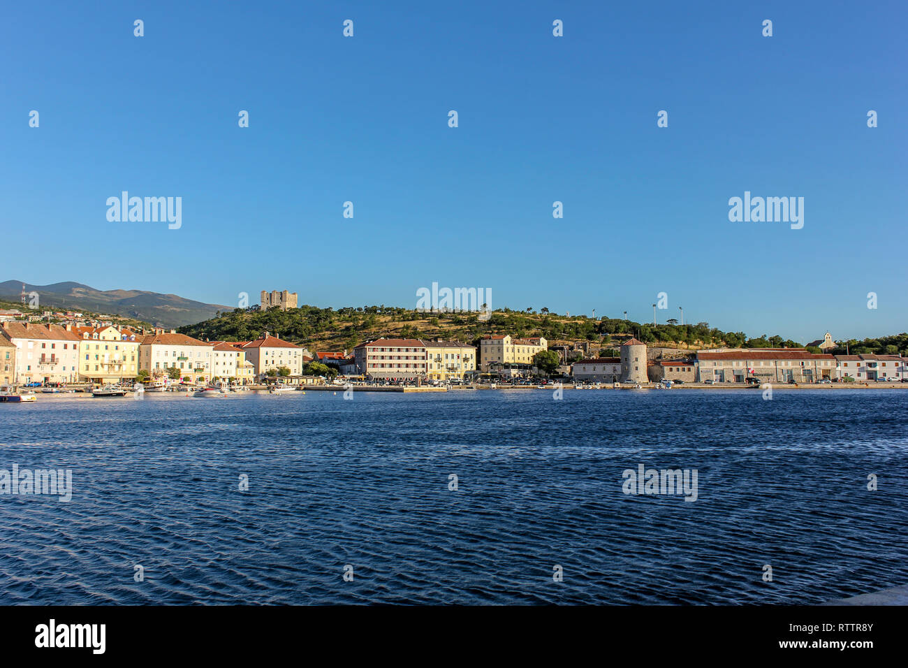 Panorama of Senj harbour and sea front with the Nehaj fortress overlooking the small sea port town & harbour.  Croatia. Stock Photo