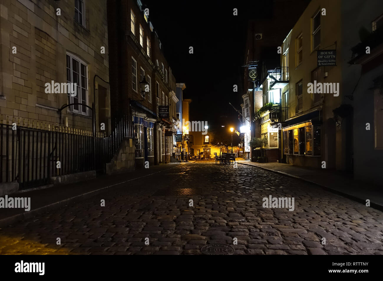 Church Street in Windsor, Berkshire, UK at night. Church Street is a cobbled, pedestrianized street with pubs, restaurants and tourist shops. Stock Photo