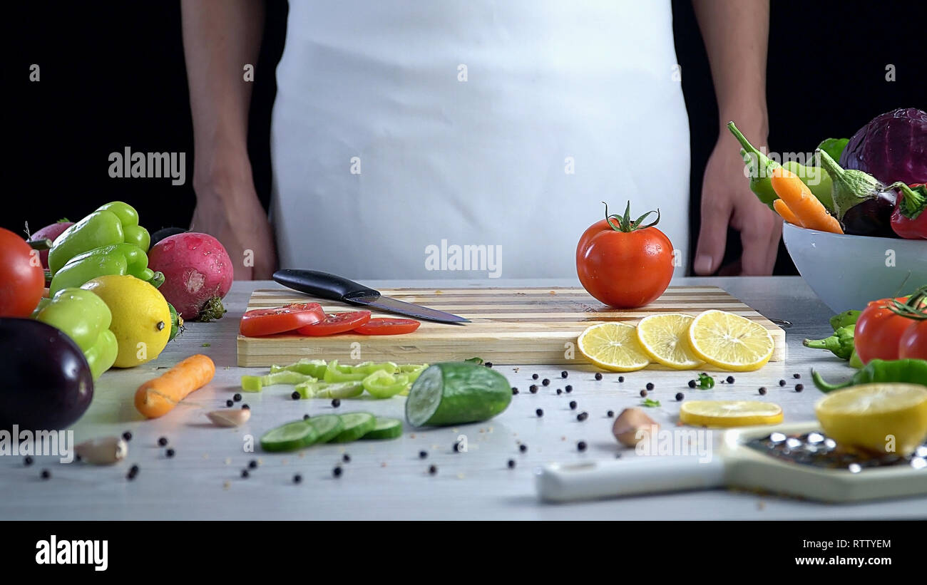 Tomato on the cutting board waits to get sliced Stock Photo - Alamy