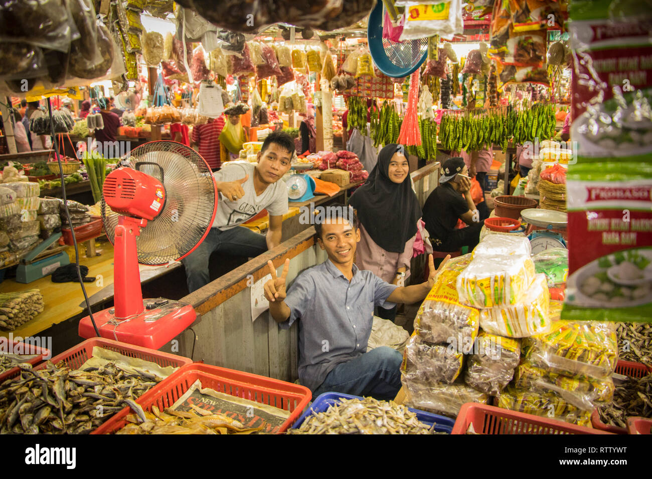 market traders pose in fruit and vegetable stall in Chow Kit Market