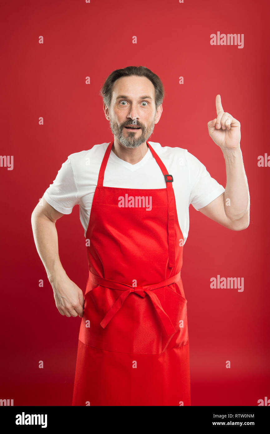 Something new. Cook with beard and mustache wearing apron red ...