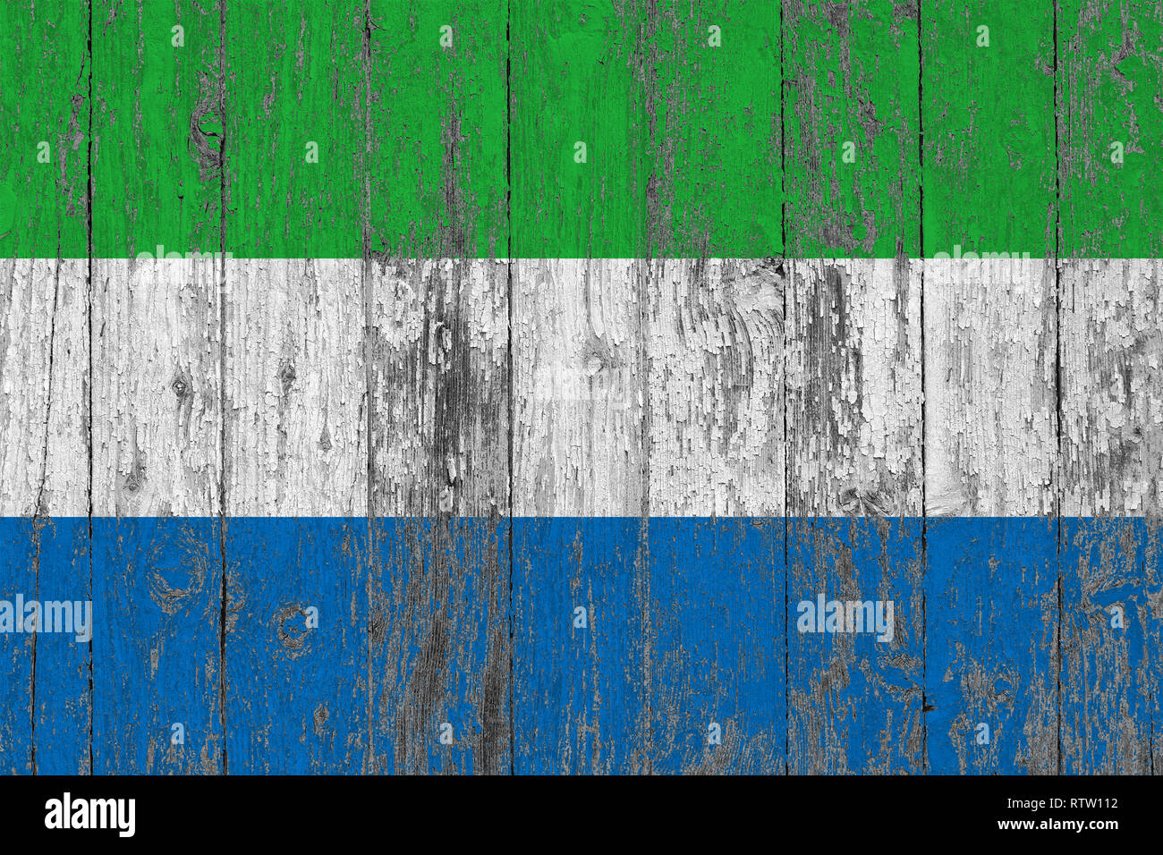 Flag of Sierra Leone painted on worn out wooden texture background ...