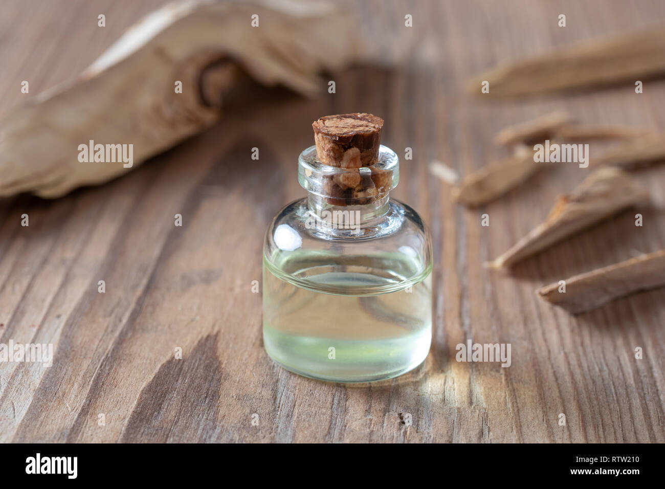 A bottle of essential oil with white sandalwood Stock Photo Alamy