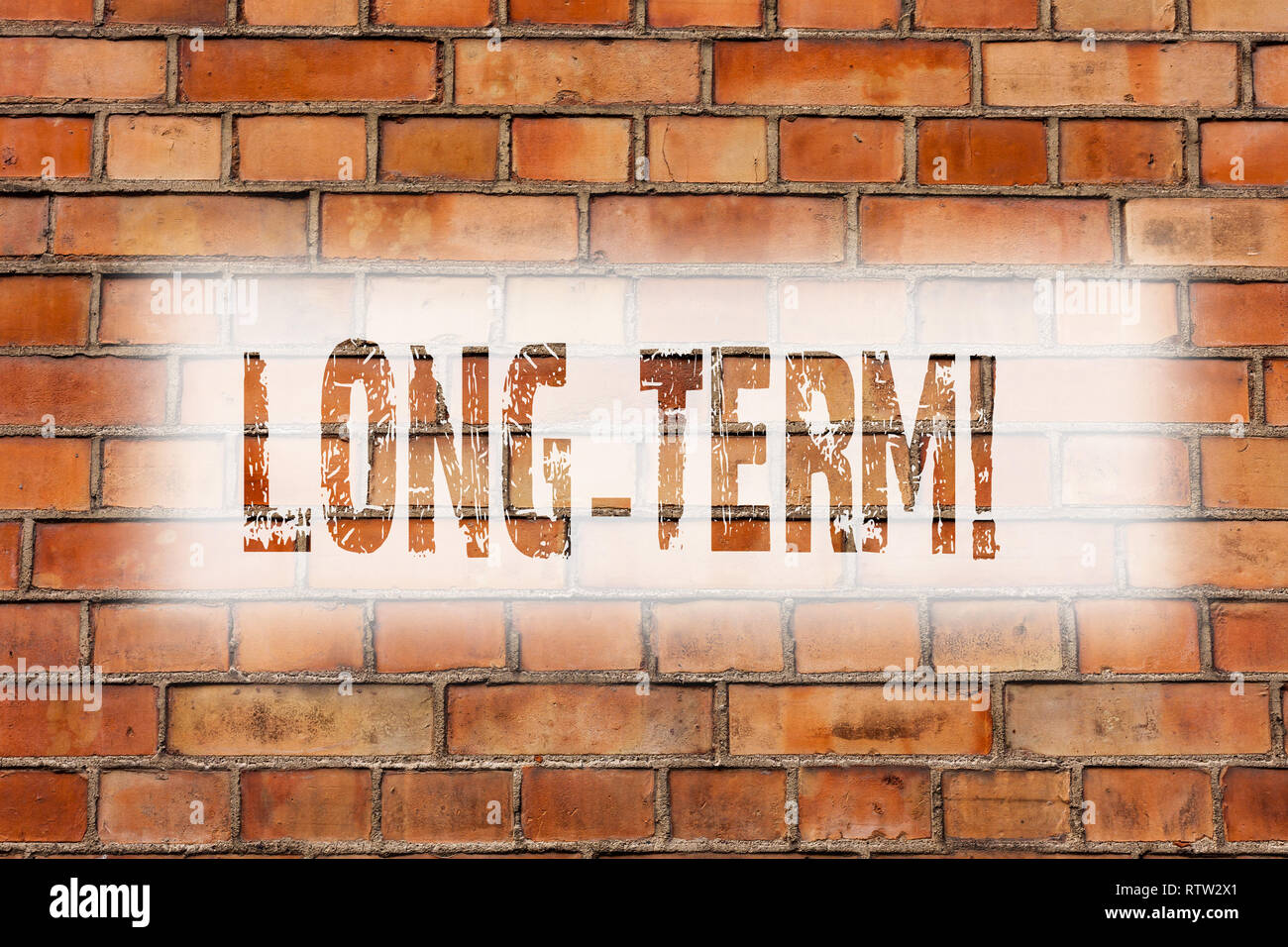 Writing note showing Long Term. Business photo showcasing Occurring over large period of time Future plans Brick Wall art like Graffiti motivational c Stock Photo