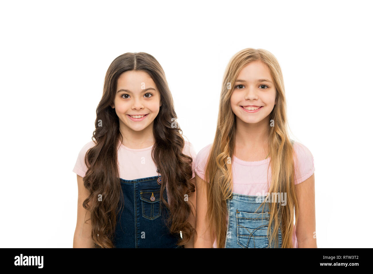 Perfect hairstyles to make a major impact. Pretty small girls with long  hairstyle. Cute little girls wearing new hairstyle. Kids hair care and  grooming. Natural hair styling and dressing. Hair salon Stock