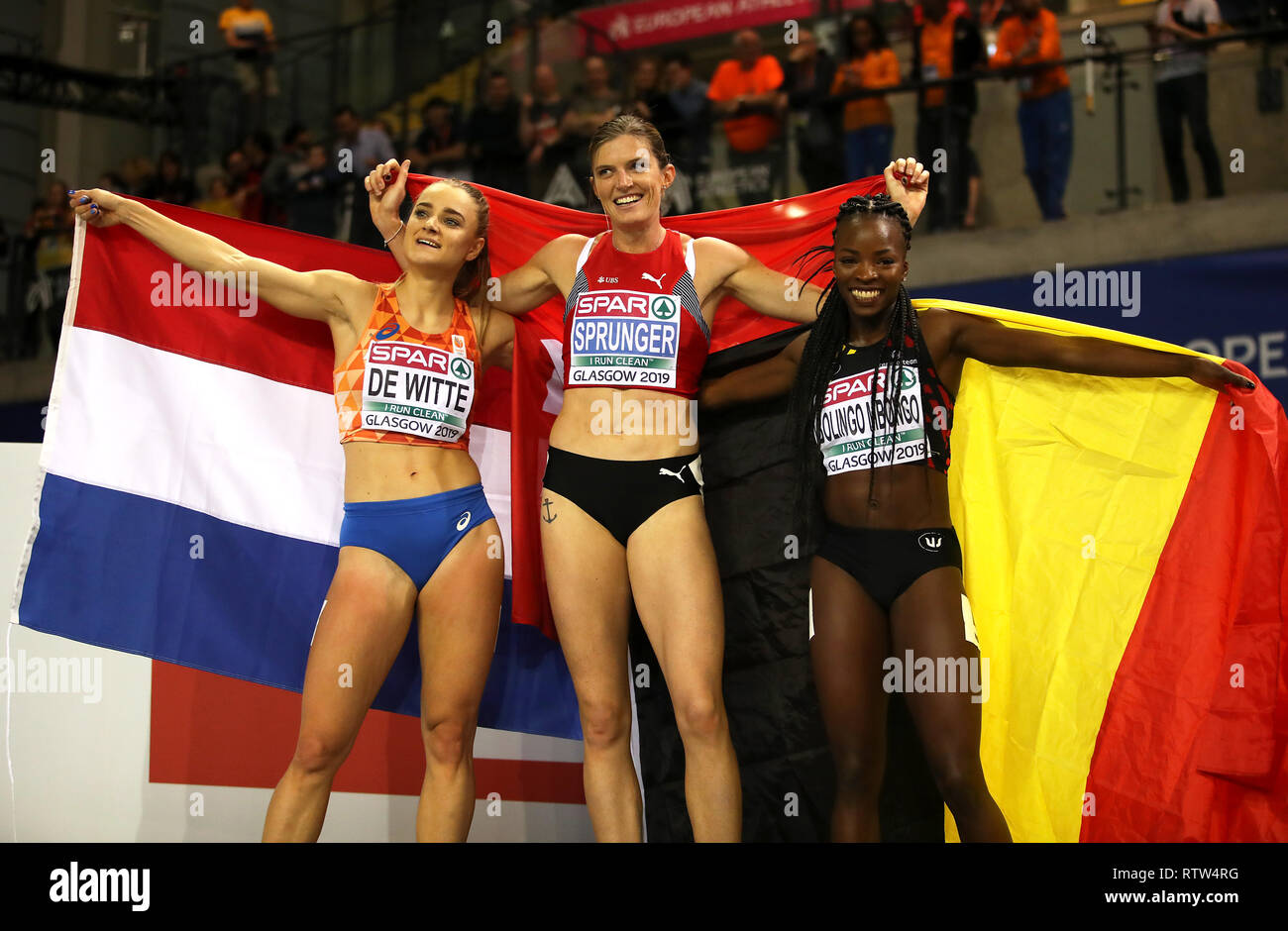 Switzerland's Lea Sprunger (centre), Netherland's Lisanne de Witte (left) and Belgium's Cynthia Bolingo Mbongo celebrate after the Women's 400m final during day two of the European Indoor Athletics Championships at the Emirates Arena, Glasgow. Stock Photo