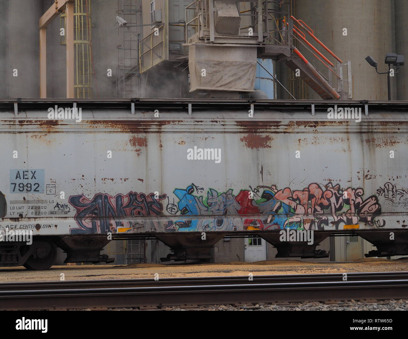 Loading of grain into a graffiti covered railroad car in Circleville Ohio wide shot Stock Photo