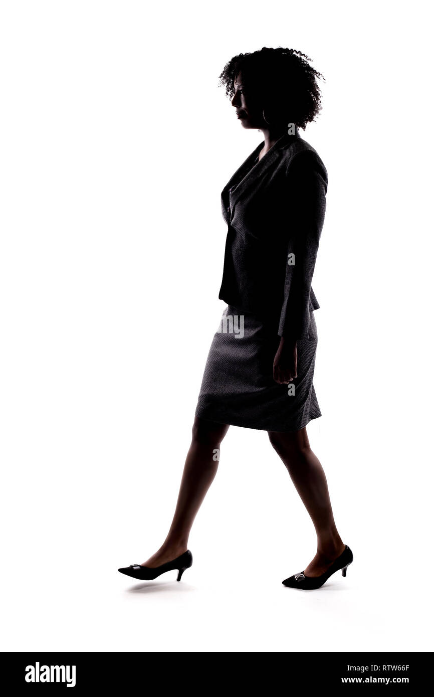 Silhouette of a Black Businesswoman walking in side view isolated on a ...