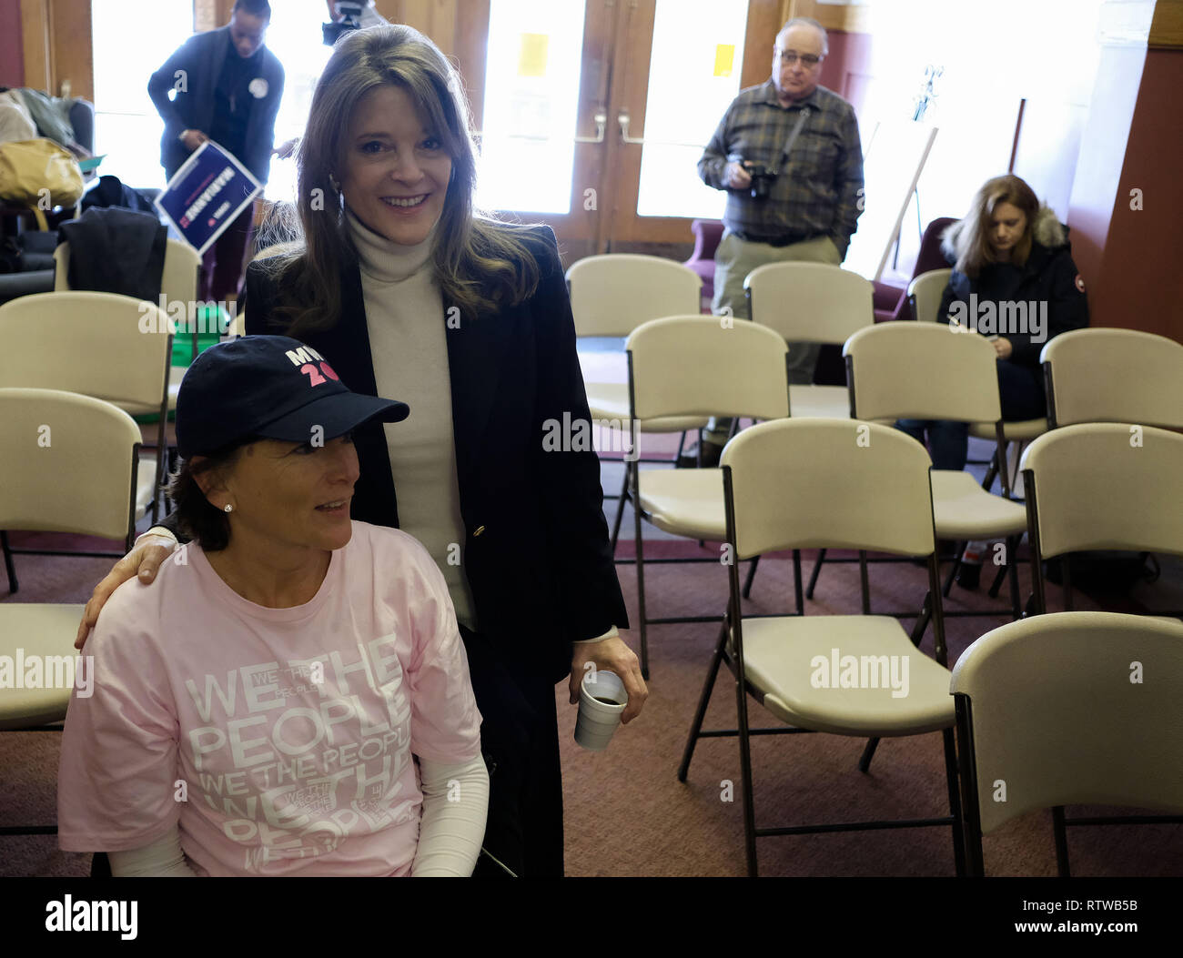 Denison, IOWA, USA. 2nd Mar, 2019. Author and spiritual guru MARIANNE WILLIAMSON, standing, poses with TONYA LAMBERTZ of Yankton, SD who is wearing a Marianne 2020 hat before speaking at the Donna Reed Theatre in Denison, Iowa Saturday, March 2, 2018, and exploring a presidential run for 2020. Credit: Jerry Mennenga/ZUMA Wire/Alamy Live News Stock Photo
