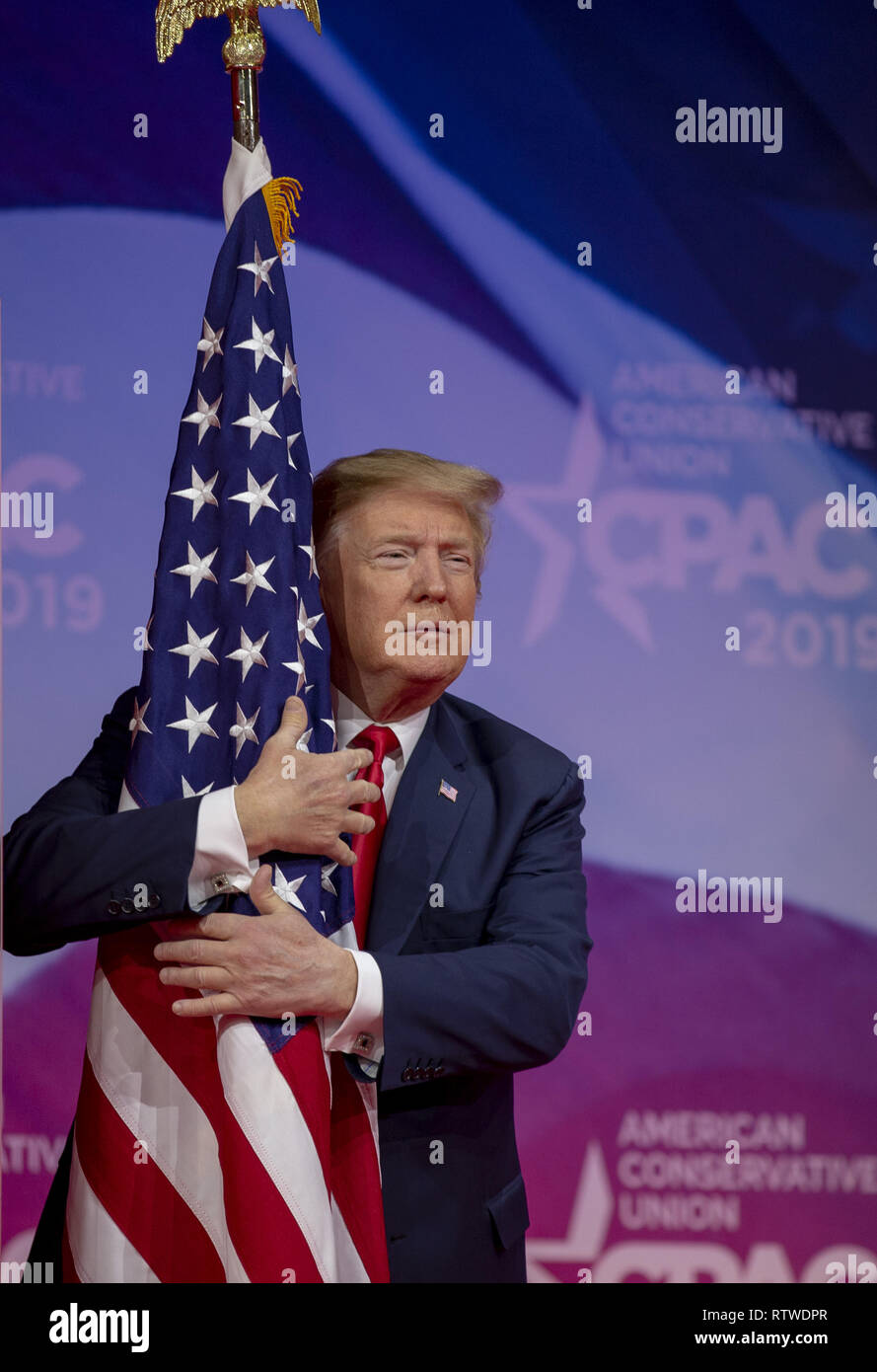 https://c8.alamy.com/comp/RTWDPR/us-president-donald-trump-hugs-the-us-flag-during-cpac-2019-on-march-02-2019-in-washington-dc-the-american-conservative-union-hosts-the-annual-conservative-political-action-conference-to-discuss-conservative-agenda-credit-tasos-katopodispool-via-cnpmediapunch-RTWDPR.jpg