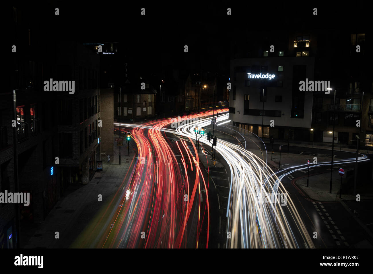 Lewisham night London street with passing cars Stock Photo