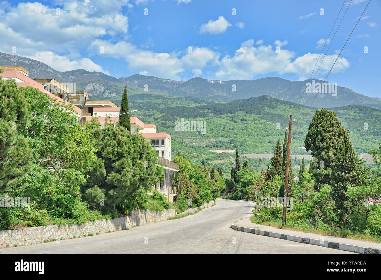 = Gurzuf Road and Crimean Mountains with Cloudy Sky =  Beautiful spring Crimean landscape in Gurzuf with the view from Gurzufsskoye Shosse (Gurzuf hig Stock Photo