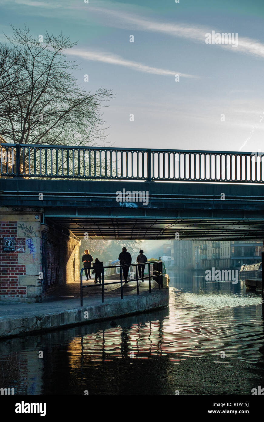 Commuters in the early morning light on the Regents Canal, London near Kings Cross, England Stock Photo