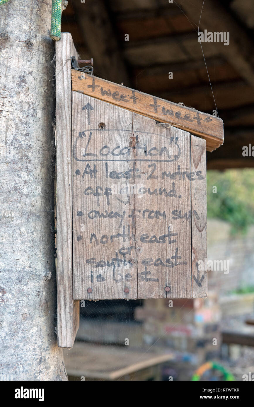Wooden nestbox with advice for it's location written onto the side. Stock Photo