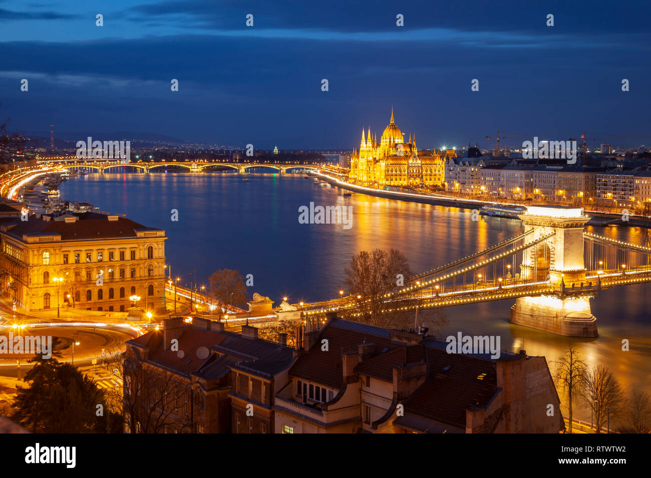 Night falls in Budapest, Hungary. Chain Bridge and Parliament in the distance. Stock Photo