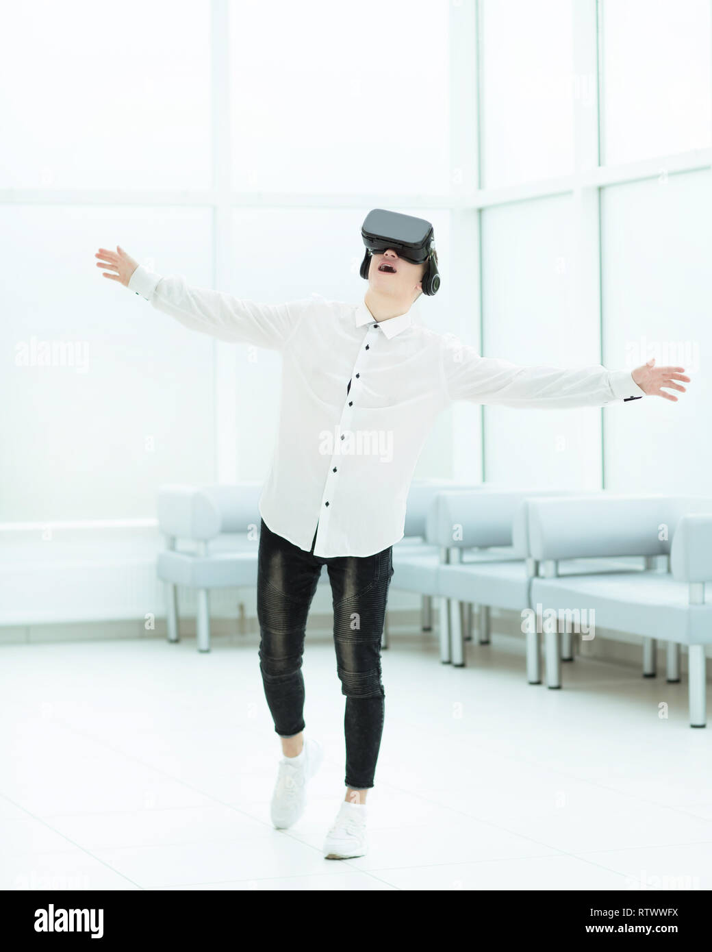 in full growth.a delighted developer is testing virtual reality glasses. Stock Photo