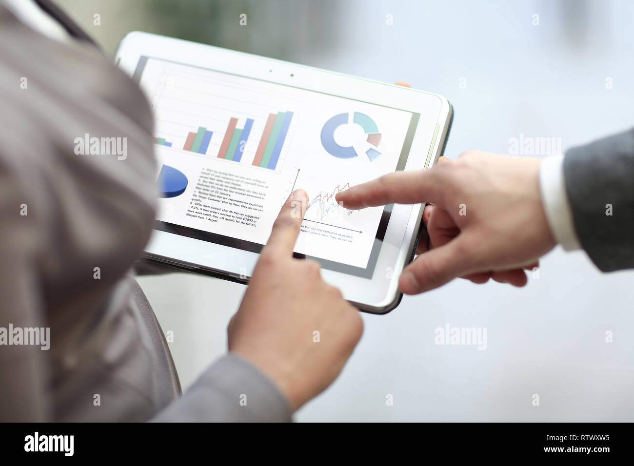 close up. colleagues discuss financial data using a digital tablet Stock Photo
