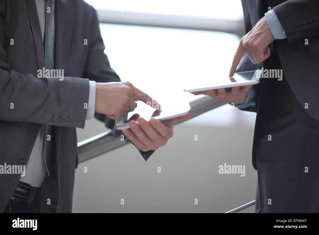 close up. two businessmen with tablet computers Stock Photo
