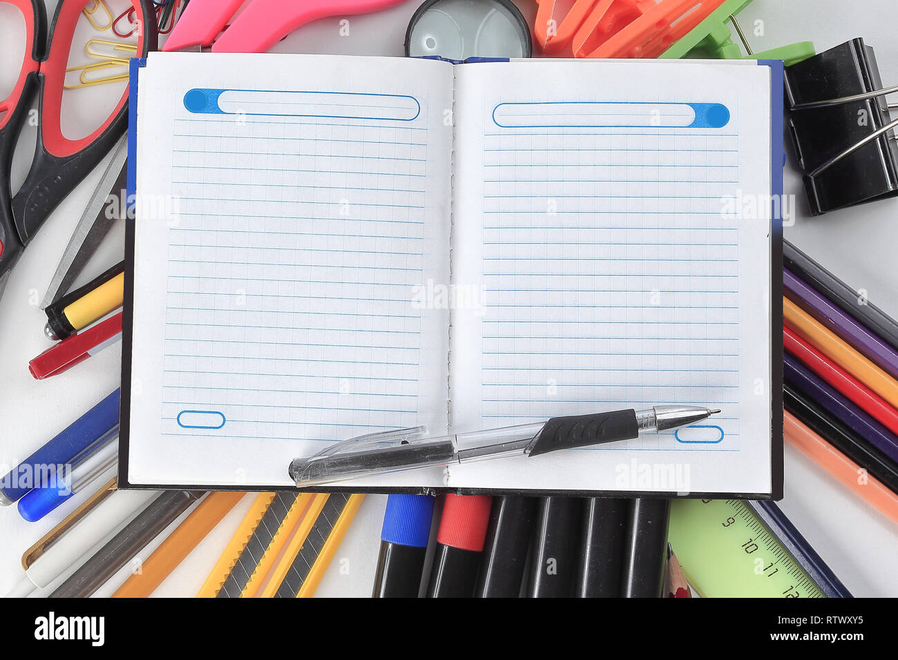 opened Notepad on office supplies on white background Stock Photo