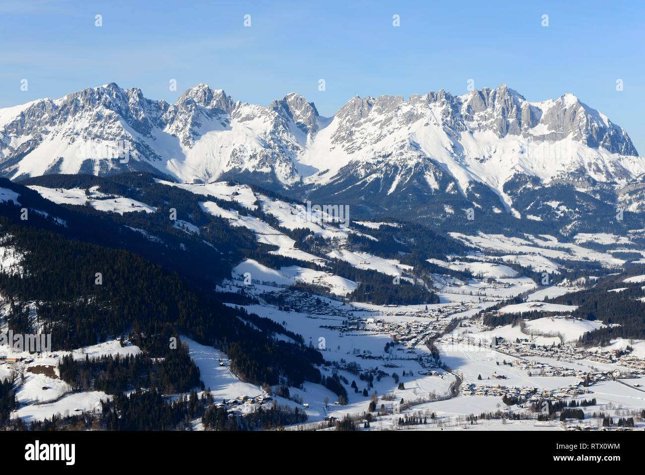 Snow-covered mountain massif Wilder Kaiser in winter with St. Johann in Tyrol, Kitzbüheler Alps, Tyrol, Austria Stock Photo