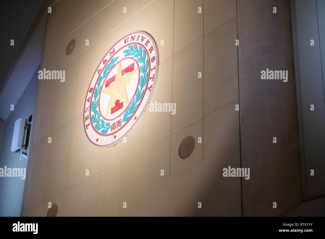 Texas A&M University seal on the Reed Arena at night, home of the