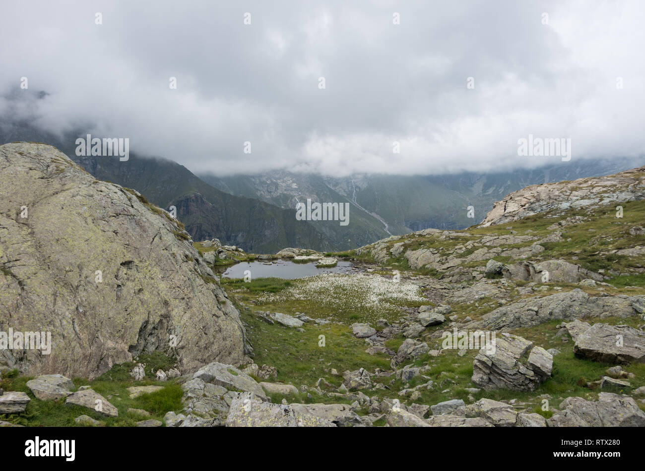 View to valley Bors from mountain slope with litile pond , Alagna Valsesia area, Italy Stock Photo