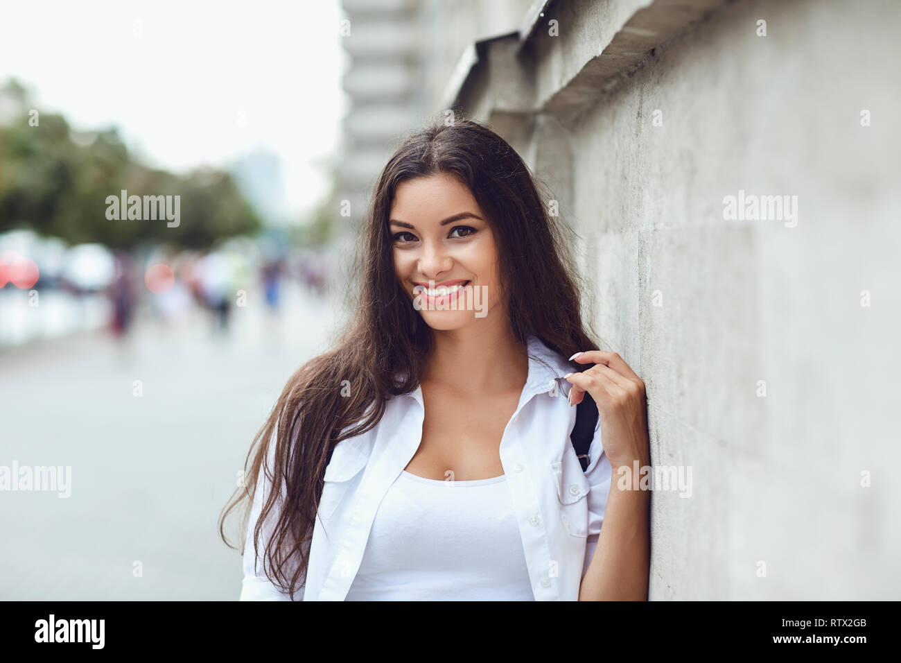 Beautiful happy brunette woman smiling outdoors.  Stock Photo