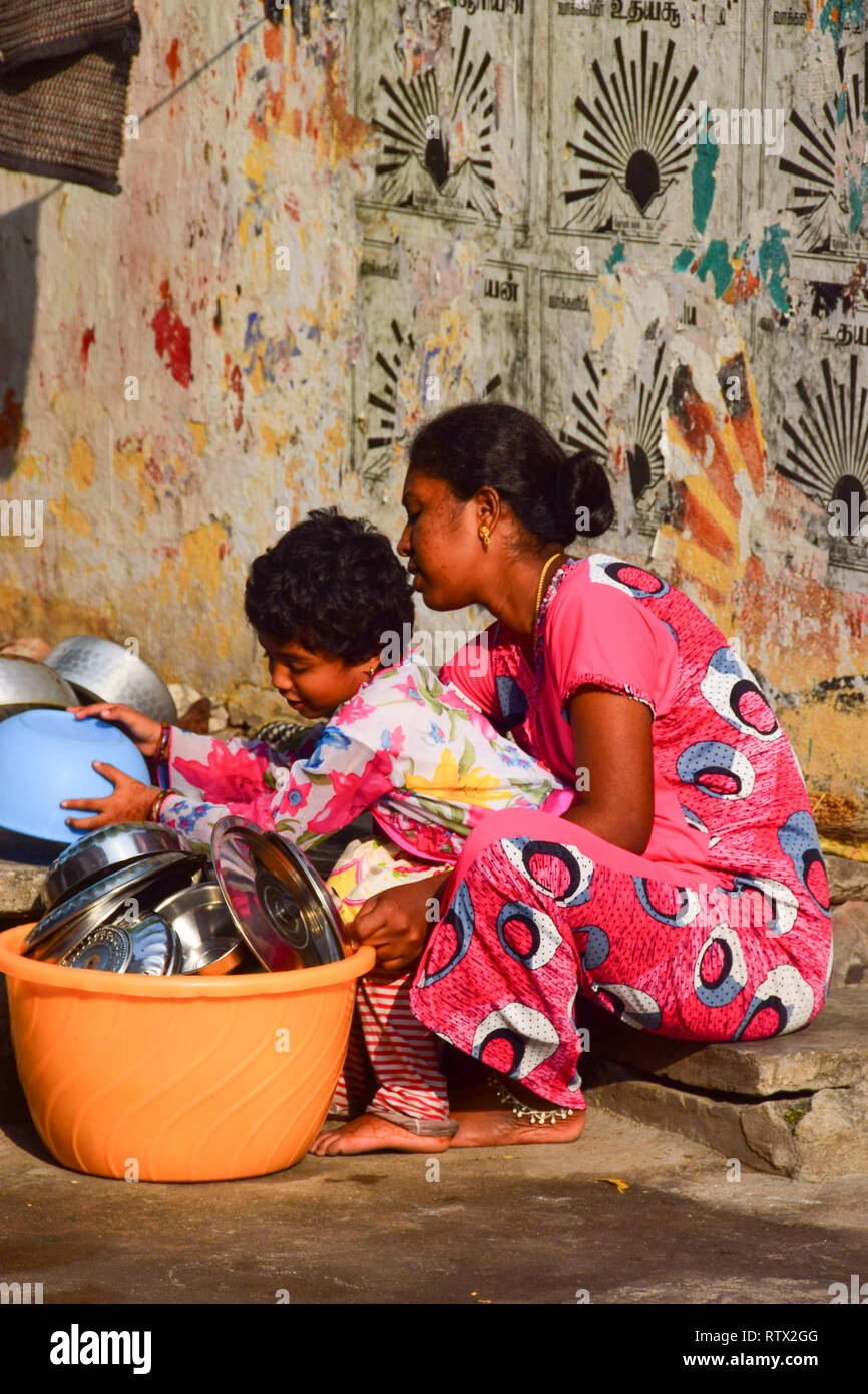 Washing a Large Cooking Pot in an Ashram (India)