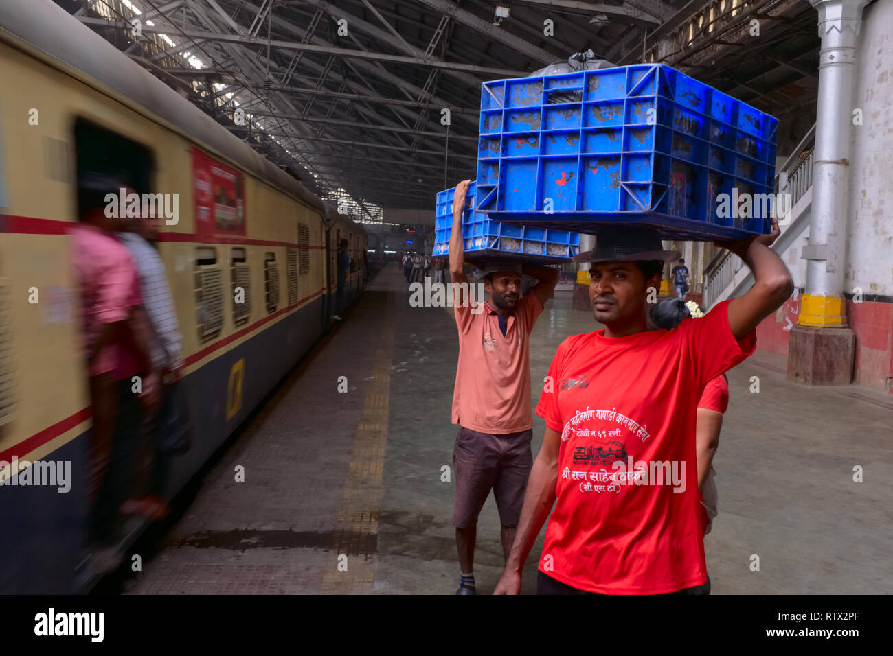 Porters waiting to deliver goods at Chhatrapati Shivaji Maharaj Terminus (CSMT) in Mumbai, India, the city's busiest railway station Stock Photo