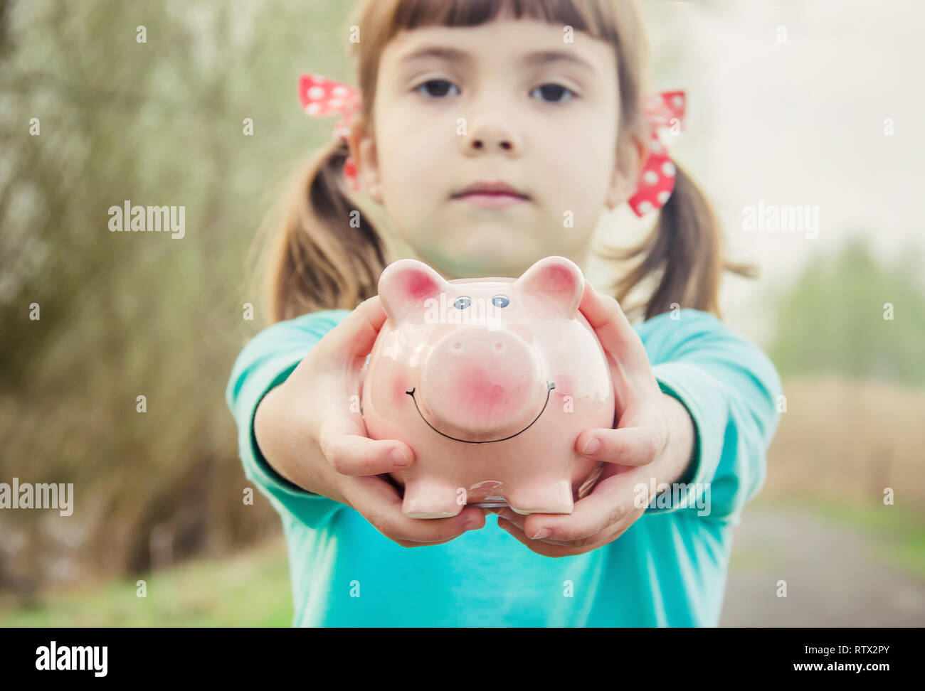 piggy bank in the hands of a child. saving. selective focus Stock Photo ...