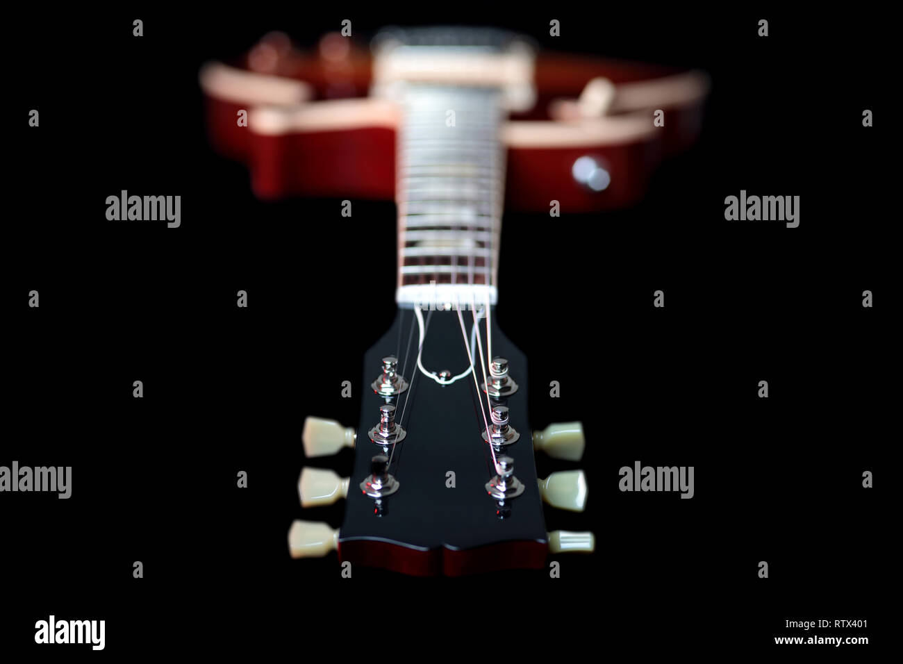 Headstock and machine head tuners of a new Gibson Les Paul Traditional electric guitar. The headstock is in focus with the fretboard and body behind. Stock Photo