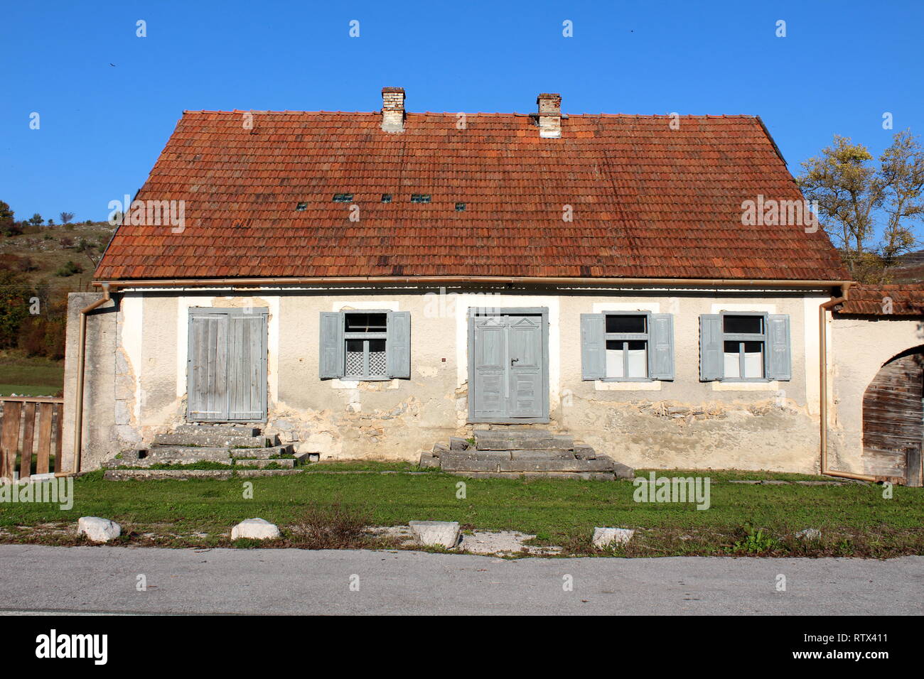 Old abandoned traditional family house with dilapidated facade and ...