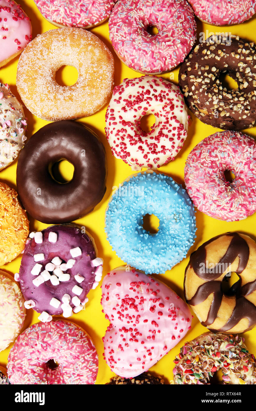 assorted donuts with chocolate frosted, pink glazed and sprinkles ...