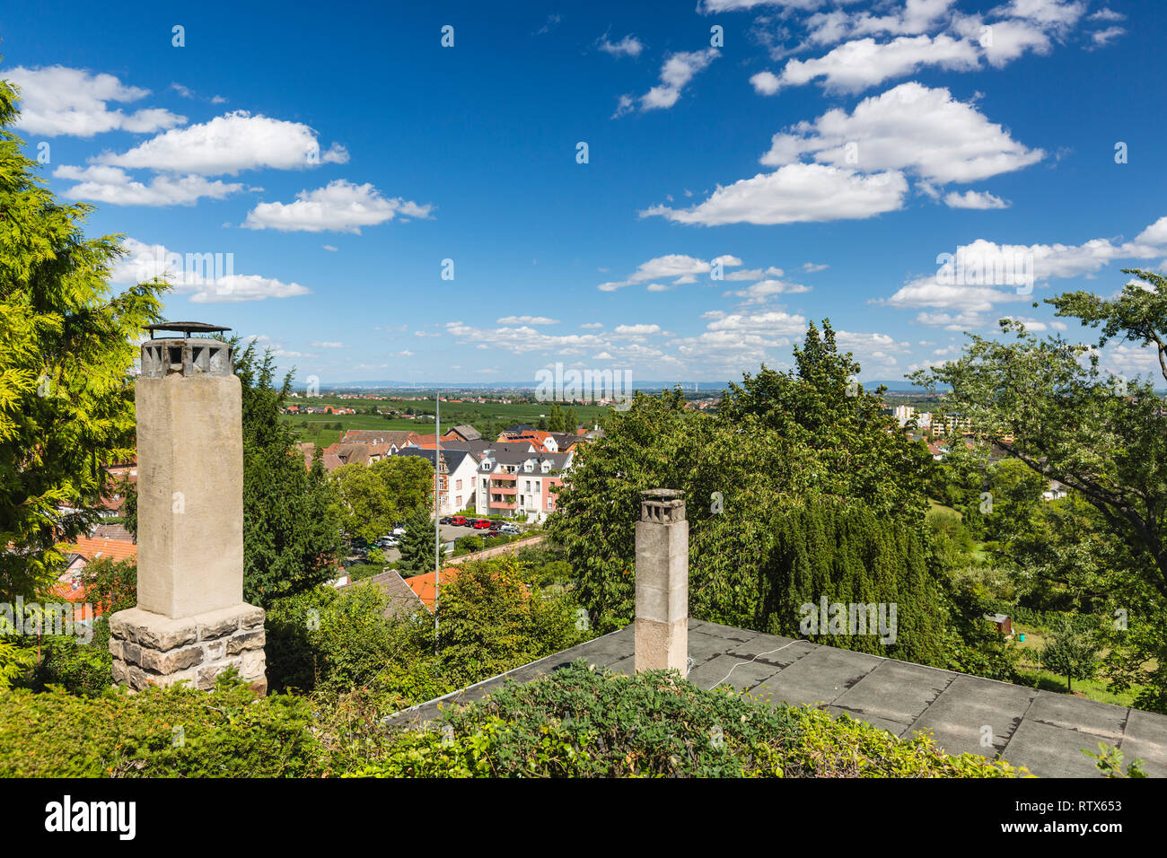 View from a hill over Neustadt an der Weinstrasse, Germany on a clear summer day to the distant mountains of the Odenwald. Stock Photo