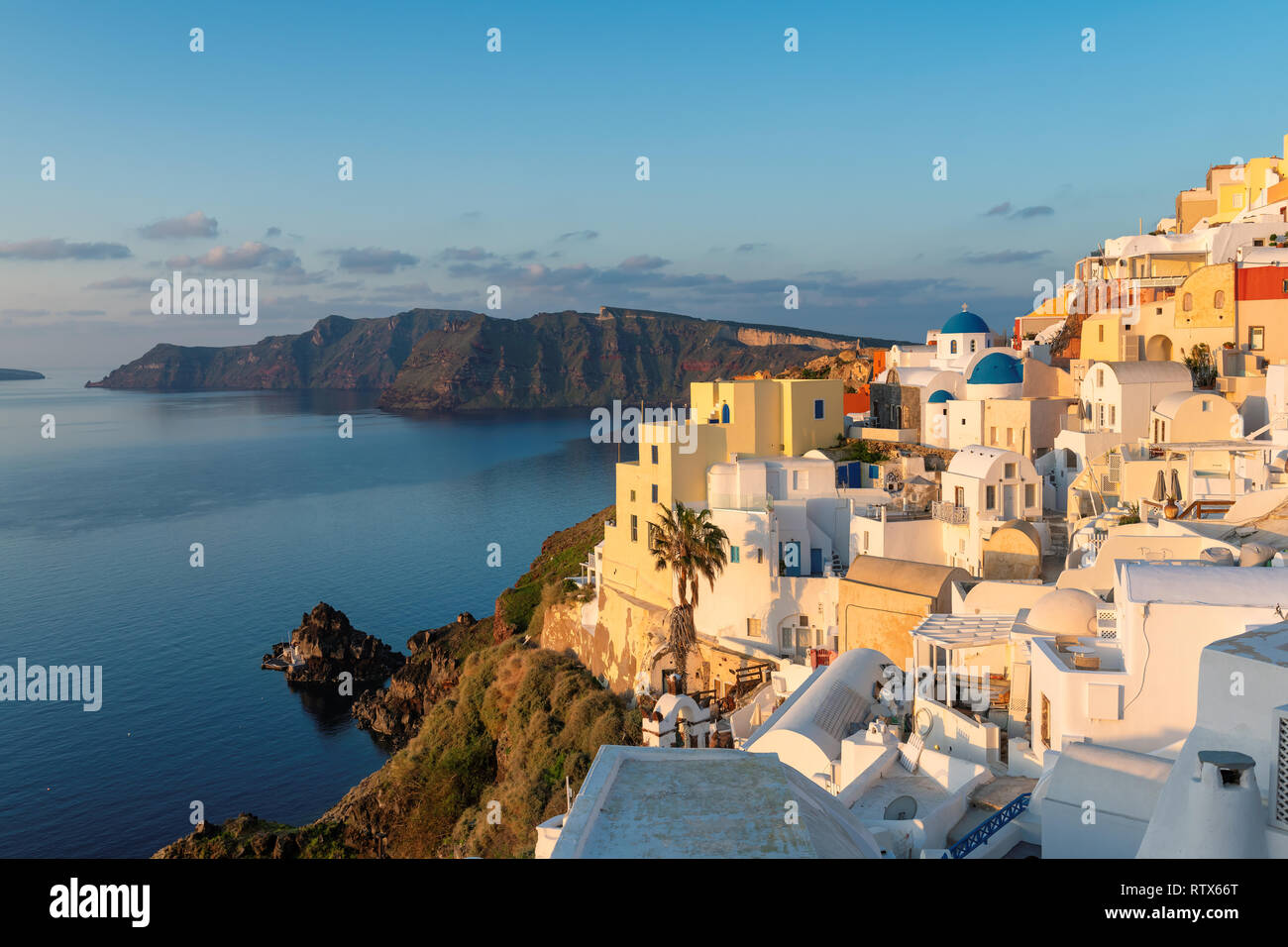 Spectacular Oia town at sunrise on Santorini island, Greece Stock Photo ...