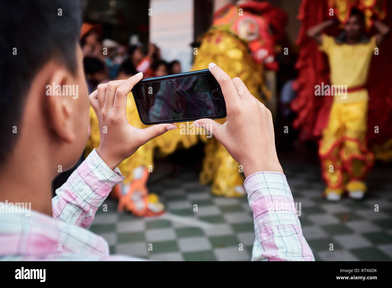 Dragon dancers usher in the new year by performing a dance ritual outside local businesses in celebration of the Chinese New Year Stock Photo
