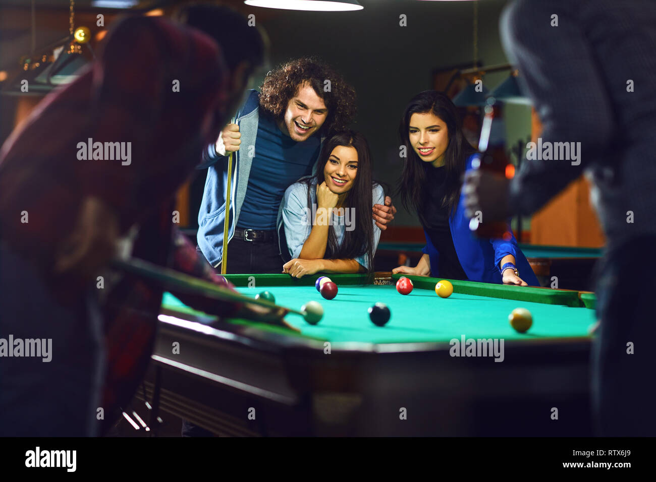 Friends play billiards. Stock Photo