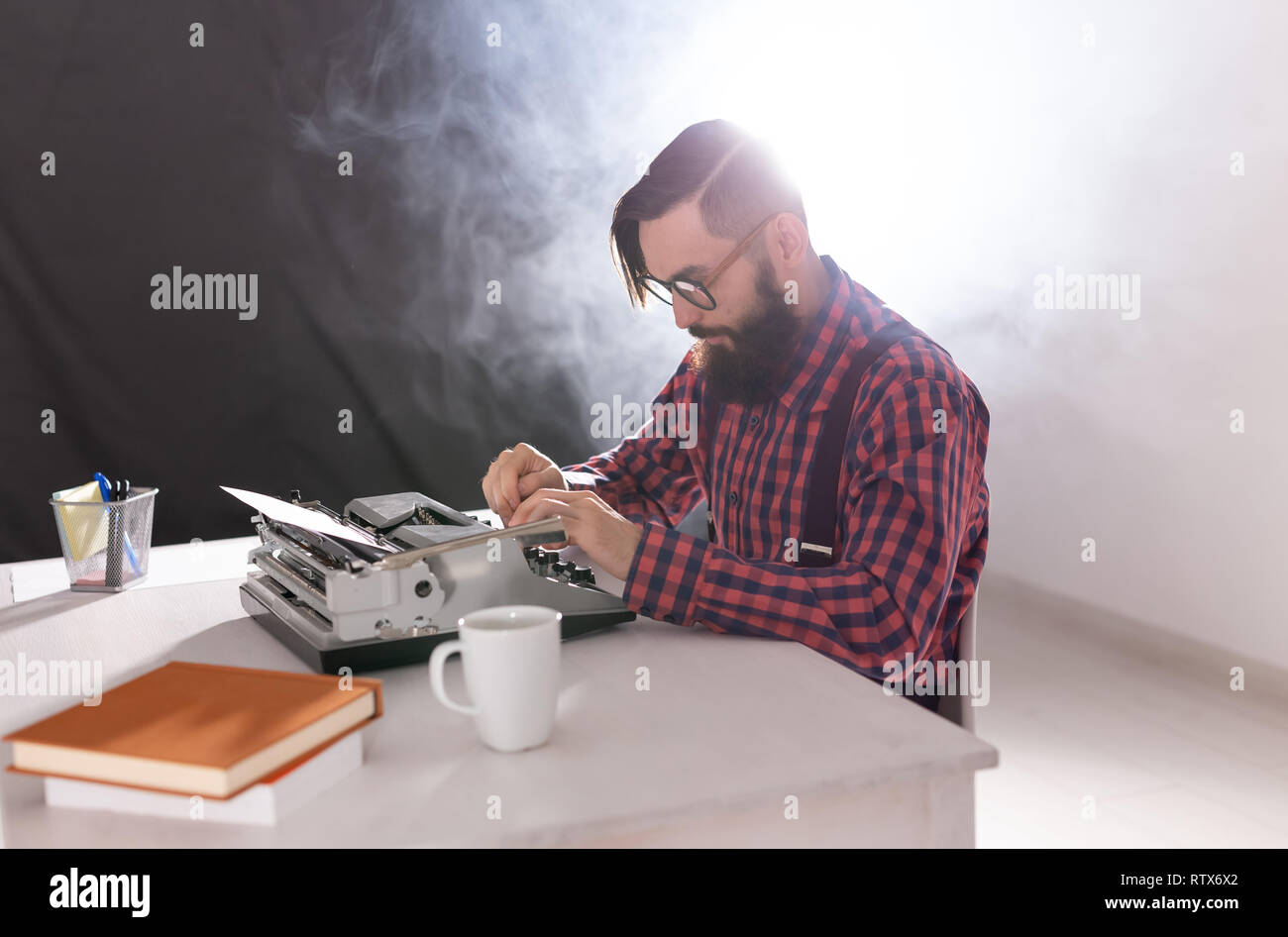 Young writer working on his new work hi-res stock photography and ...