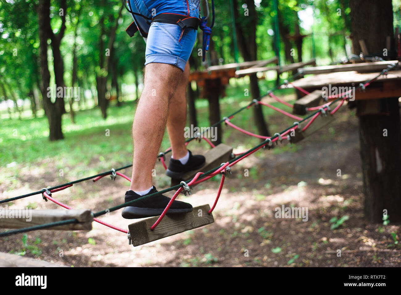 Hiking in the rope park beautiful sports guy Stock Photo Alamy