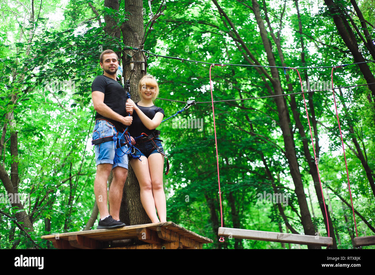 Hiking in the rope park two young people Stock Photo Alamy
