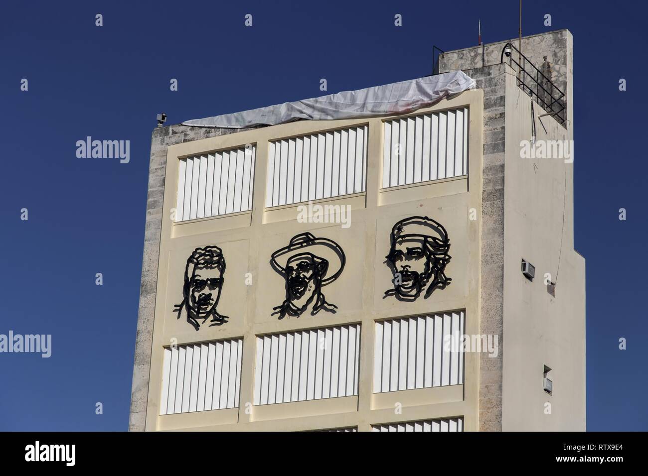 Metal Faces of Fidel Castro, Ernesto Che Guevara and Camilo Cienfuegos on Building Wall Mural near Revolution Museum in old Havana, Cuba Stock Photo