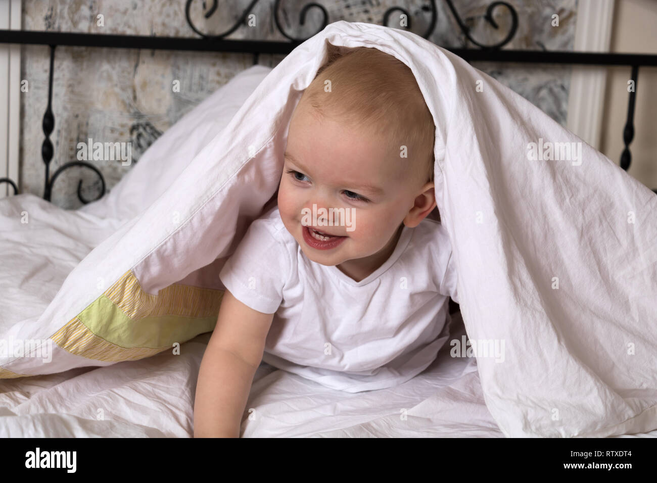 Kid hiding under blanket hires stock photography and images Alamy
