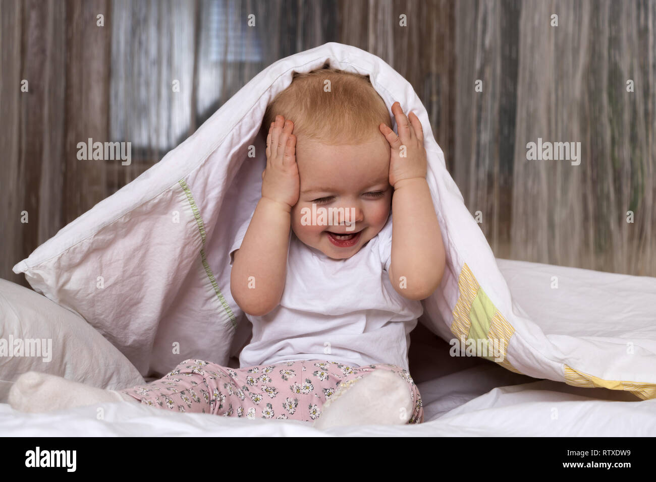 Kid hiding under blanket hires stock photography and images Alamy