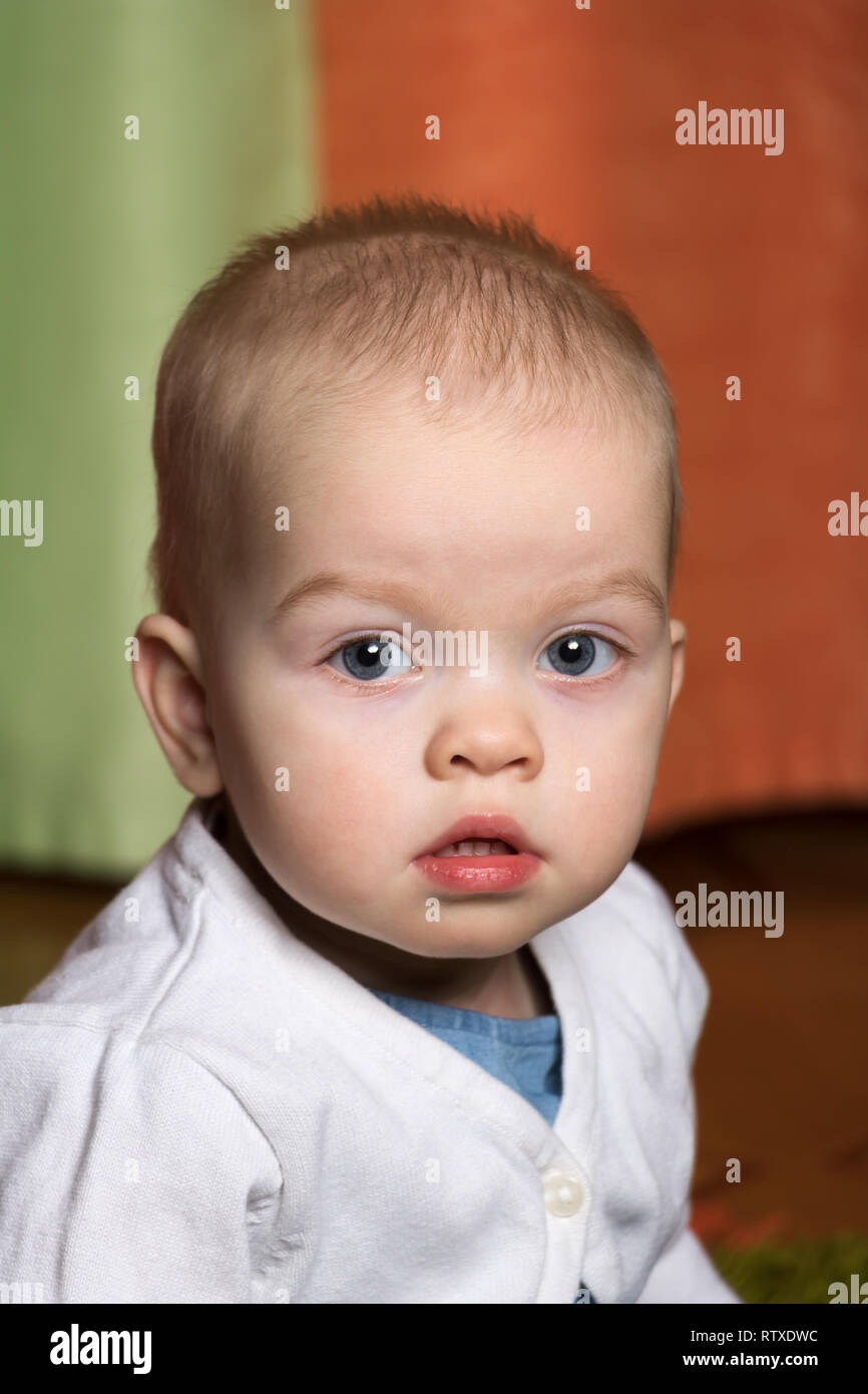 portrait of a cute baby in a white sweater Stock Photo