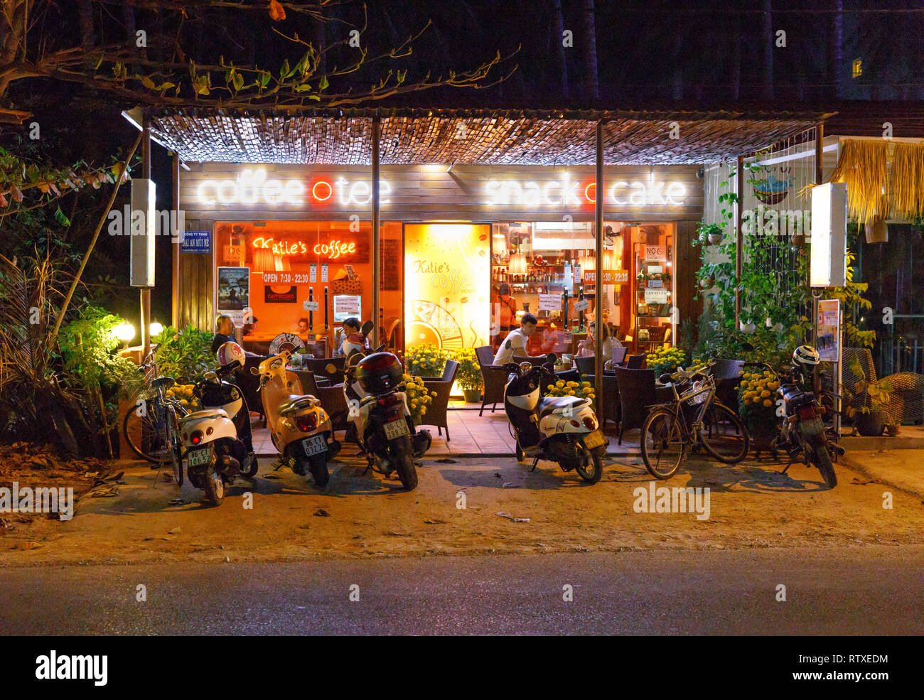 NAM TIEN, VIETNAM - FEBRUARY 15, 2018: Scooters and motor bikes in front of cafe at night in Nam Tien, Vietnam on February 15, 2018 Stock Photo