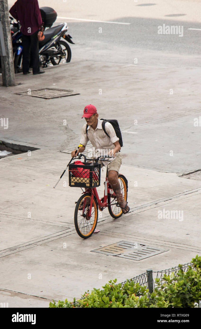 Local Malaysian Man Riding Bike In Street In Kuala Lumpur Malaysia Stock Photo Alamy