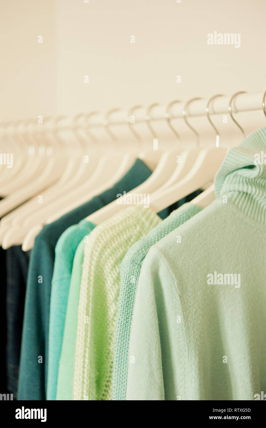 rack with hanging sweaters Stock Photo