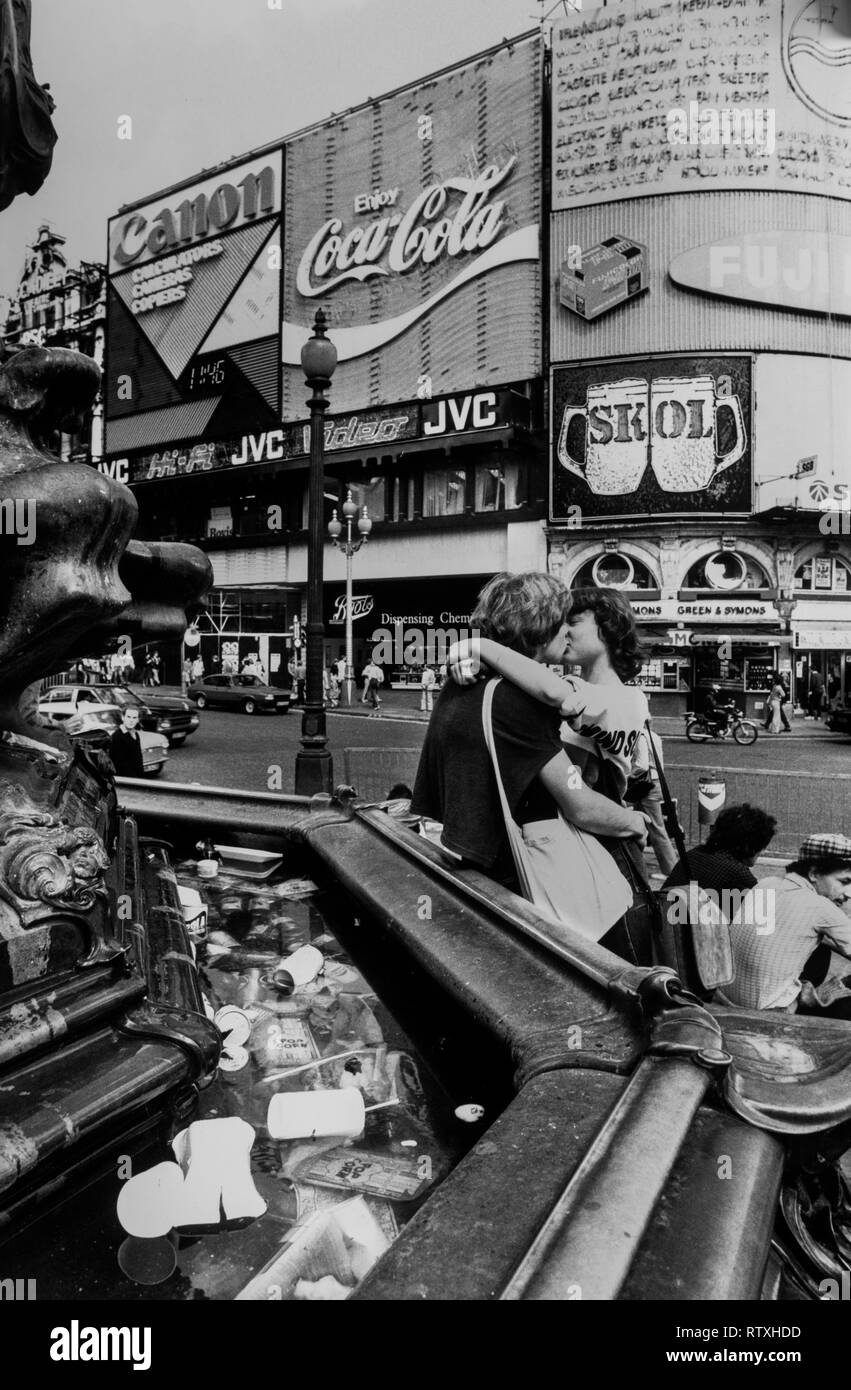 Piccadilly Circus London England. 1977 Kissing couple under the 