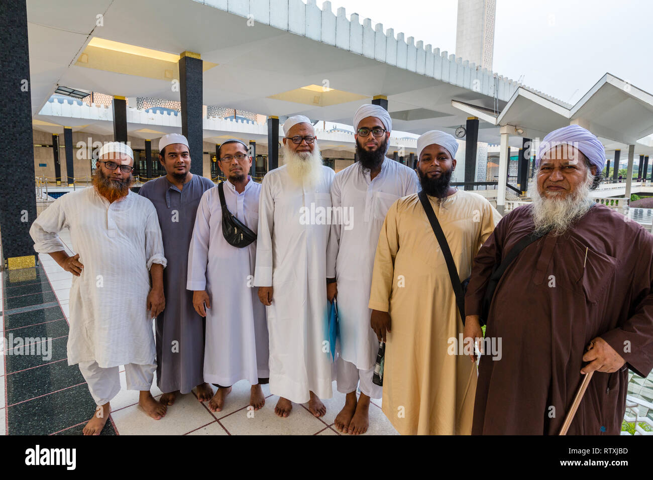 Bangladeshi Men Visiting the Masjid Negara (National Mosque) in Kuala Lumpur, Malaysia. Stock Photo