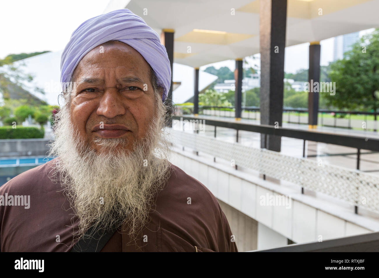 Bangladeshi Imam Visiting the Masjid Negara (National Mosque) in Kuala Lumpur, Malaysia. Stock Photo